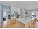 Well-lit kitchen with white cabinets, stainless steel appliances, and kitchen island at 101 Overlake Dr, Chapel Hill, NC 27516
