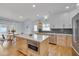 Bright kitchen with white cabinets, stainless steel appliances, island and breakfast nook at 101 Overlake Dr, Chapel Hill, NC 27516