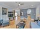 Open-concept living room with hardwood floors, blue walls, fireplace and open floor plan at 101 Overlake Dr, Chapel Hill, NC 27516