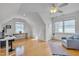 Bright office space featuring built-ins, hardwood floors, and a ceiling fan at 101 Overlake Dr, Chapel Hill, NC 27516