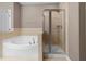 A bathroom with a soaking tub and separate glass shower at 1012 Palace Garden Way, Raleigh, NC 27603