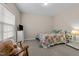 Cozy bedroom with a floral quilt, a window with blinds, and a dresser with a small TV at 1012 Palace Garden Way, Raleigh, NC 27603