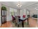 Dining room featuring hardwood floors, wainscoting, and abundant natural light at 1012 Palace Garden Way, Raleigh, NC 27603