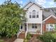 Inviting two-story home featuring a covered front porch and well-maintained landscaping at 1012 Palace Garden Way, Raleigh, NC 27603