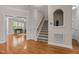 Foyer featuring hardwood floors, staircase, and an arched display case at 1012 Palace Garden Way, Raleigh, NC 27603