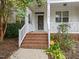 Charming front porch with brick steps, white railings, and inviting entrance at 1012 Palace Garden Way, Raleigh, NC 27603