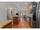 A kitchen with granite countertops, stainless steel appliances, and hardwood floors at 1012 Palace Garden Way, Raleigh, NC 27603