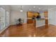 This kitchen offers wooden cabinetry, stainless appliances, and hardwood floors throughout at 1012 Palace Garden Way, Raleigh, NC 27603