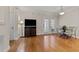 A living room with hardwood floors, a TV, and a table with chairs at 1012 Palace Garden Way, Raleigh, NC 27603