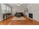 Cozy living room with hardwood floors, fireplace, and comfortable leather seating at 1012 Palace Garden Way, Raleigh, NC 27603