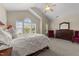 Bright main bedroom with cathedral ceiling, large windows and comfortable furnishings at 1012 Palace Garden Way, Raleigh, NC 27603