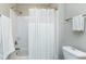 Clean, white bathroom featuring a shower and tub combination with a shower curtain at 104 Musgrove Cir, Cary, NC 27518