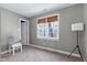 This cozy bedroom with a bird cage is next to a bright window with natural light and a side door at 104 Musgrove Cir, Cary, NC 27518