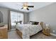 Cozy bedroom featuring a comfortable bed, side table and window with natural lighting at 104 Musgrove Cir, Cary, NC 27518
