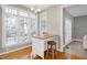 Sun-filled breakfast nook features bright windows, hardwood floors, and chandelier at 104 Musgrove Cir, Cary, NC 27518