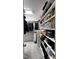 Spacious walk-in closet with custom shelving for shoes, handbags and hanging clothes at 104 Musgrove Cir, Cary, NC 27518