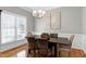 Bright dining room with hardwood floors, chandelier, wainscoting, and modern decor at 104 Musgrove Cir, Cary, NC 27518