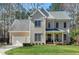 Two-story home featuring a two-car garage, a gabled roof, and a well-maintained front lawn at 104 Musgrove Cir, Cary, NC 27518