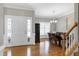 Foyer with hardwood floors, staircase, chandelier, and dining room view at 104 Musgrove Cir, Cary, NC 27518
