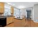 Open-concept kitchen with light wood floors, island cooktop, stainless sink and lots of natural light at 104 Musgrove Cir, Cary, NC 27518