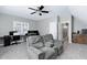 Spacious living room with reclining loveseat, ceiling fan, and a workstation with multiple monitors at 104 Musgrove Cir, Cary, NC 27518