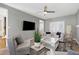 Cozy living room featuring a ceiling fan, fireplace, and plush seating at 104 Musgrove Cir, Cary, NC 27518
