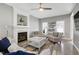 Spacious living room with fireplace, ceiling fan, and stylish furniture and decor at 104 Musgrove Cir, Cary, NC 27518