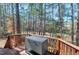 Wooden deck shows an outdoor grill surrounded by trees at 104 Musgrove Cir, Cary, NC 27518