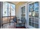 A cozy screened-in porch with outdoor furniture, a small table with a lantern, and double glass doors at 104 Musgrove Cir, Cary, NC 27518