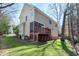 Backyard view of a tan two-story house with a screened porch and a wooden deck at 104 Musgrove Cir, Cary, NC 27518