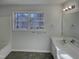 Bathroom featuring a tub and sink with a large mirror at 104 Walnut Creek Dr, Clayton, NC 27520
