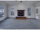 Bright living room featuring a fireplace, large windows, and hardwood floors at 104 Walnut Creek Dr, Clayton, NC 27520