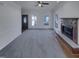 Living room with fireplace, carpet and lots of light from the windows and the entry door at 104 Walnut Creek Dr, Clayton, NC 27520