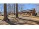 Large backyard with mature trees providing shade and privacy, perfect for outdoor activities at 1253 Skyview Dr, Mebane, NC 27302