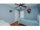 Bedroom with wooden floors, blue walls, and a ceiling fan at 1253 Skyview Dr, Mebane, NC 27302