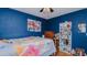 Bedroom with wooden floors, blue walls, and a ceiling fan at 1253 Skyview Dr, Mebane, NC 27302