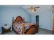Bedroom with carpeted floors, ceiling fan, and a dark wood bed at 1253 Skyview Dr, Mebane, NC 27302