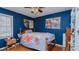 Bedroom with wooden floors, blue walls, and a ceiling fan at 1253 Skyview Dr, Mebane, NC 27302