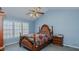 Bedroom with neutral carpet, blue walls, and a ceiling fan at 1253 Skyview Dr, Mebane, NC 27302