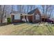 Beautiful brick home with well-kept lawn and landscaping provides exceptional curb appeal at 1253 Skyview Dr, Mebane, NC 27302