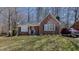 Charming brick home features a manicured lawn and a neatly paved driveway with a red SUV at 1253 Skyview Dr, Mebane, NC 27302
