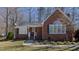 Well-maintained brick home with manicured front lawn, white trim, and classic architectural details at 1253 Skyview Dr, Mebane, NC 27302