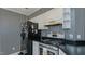 Traditional kitchen featuring black appliances, and striped wallpaper at 1253 Skyview Dr, Mebane, NC 27302