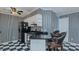 Cozy kitchen featuring black and white tile floors, gas range, and breakfast bar seating at 1253 Skyview Dr, Mebane, NC 27302