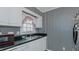 Traditional kitchen featuring black appliances, and striped wallpaper at 1253 Skyview Dr, Mebane, NC 27302