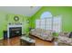 Bright living room with large windows, fireplace, and hardwood floors, creating a cozy atmosphere at 1253 Skyview Dr, Mebane, NC 27302