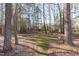 Serene backyard featuring mature trees at 126 Maltland Dr, Cary, NC 27518