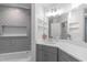 Modern bathroom featuring gray subway tile, a soaking tub, and gray vanity with a bright, white countertop at 126 Maltland Dr, Cary, NC 27518