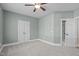 Cozy bedroom with a ceiling fan, natural light, and neutral carpet for a peaceful retreat at 126 Maltland Dr, Cary, NC 27518