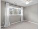 Neutral bedroom with natural light from large windows and a ceiling fan, creating a cozy atmosphere at 126 Maltland Dr, Cary, NC 27518